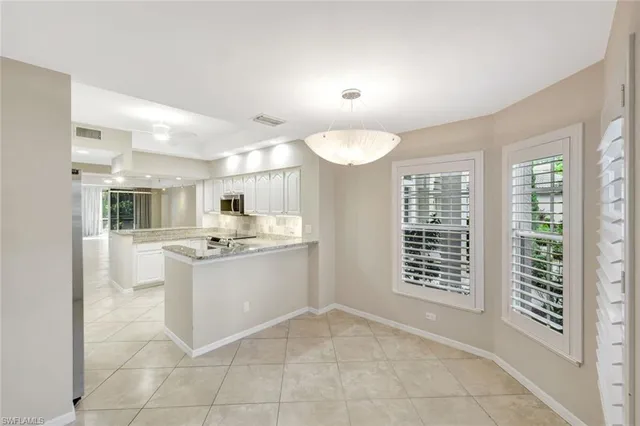a kitchen with stainless steel appliances a sink and cabinets