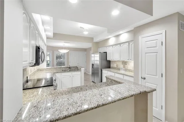 a kitchen with counter top space cabinets and stainless steel appliances