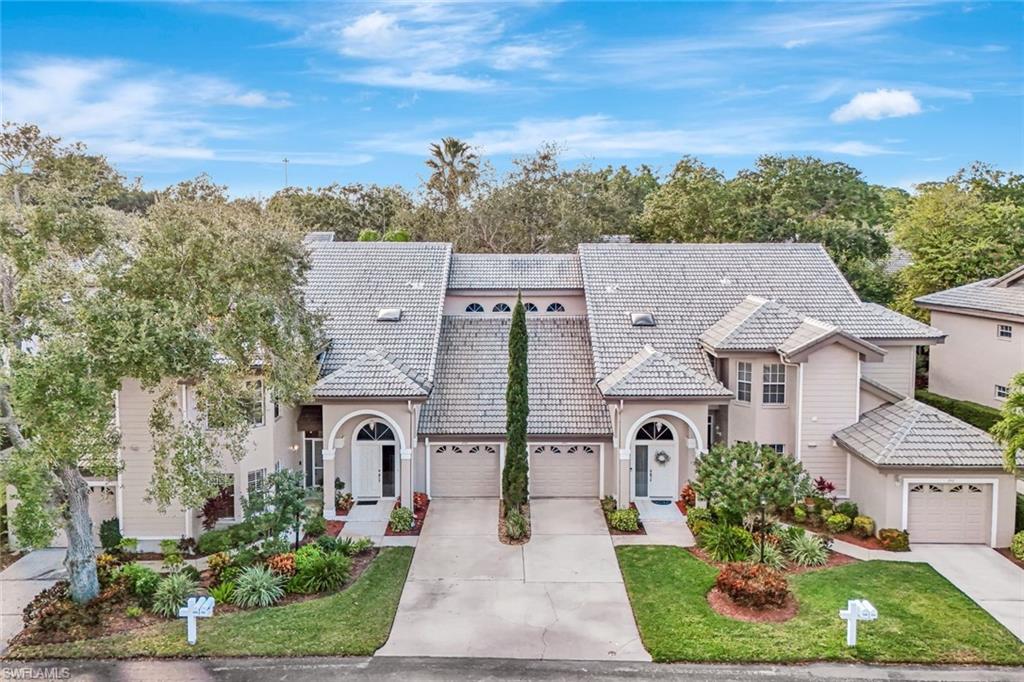 240 Via Perignon, Unit 91 Naples, FL 34119 - Photo 4 of 43 a front view of a house with a yard
