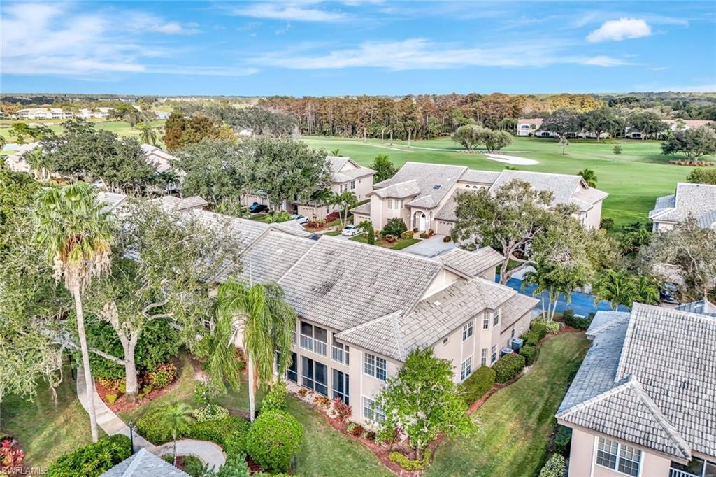 240 Via Perignon, Unit 91 Naples, FL 34119 - Photo 42 of 43 an aerial view of a house with garden space and lake view