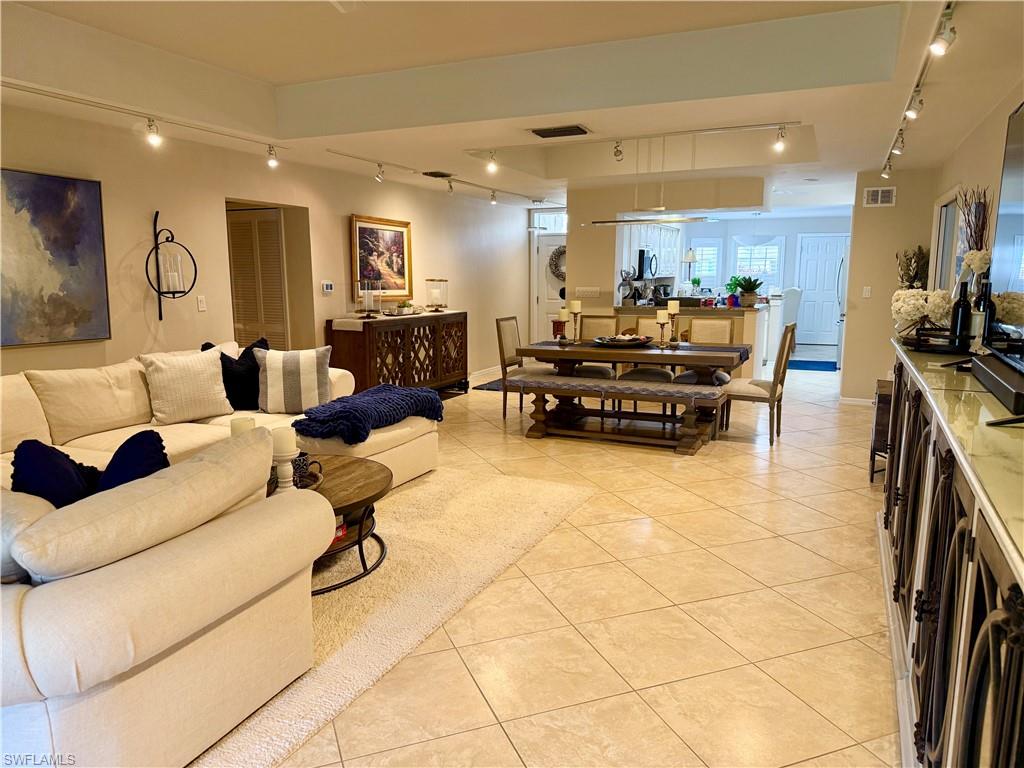 240 Via Perignon, Unit 91 Naples, FL 34119 - Photo 9 of 43 a living room with furniture and kitchen view