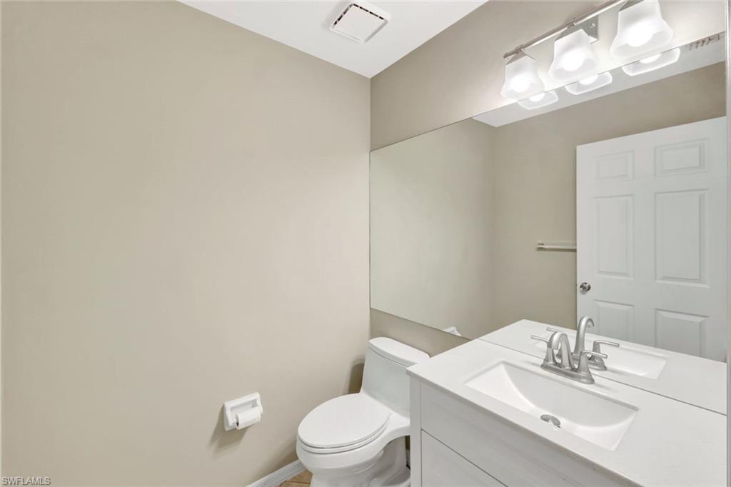 240 Via Perignon, Unit 91 Naples, FL 34119 - Photo 10 of 43 a bathroom with a toilet a sink and mirror