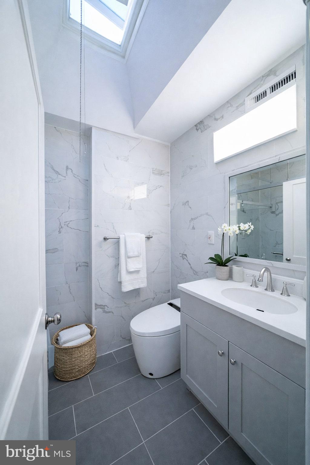 8659 Fayette Street Philadelphia, PA 19150 - Photo 11 of 47 a bathroom with a toilet sink and mirror