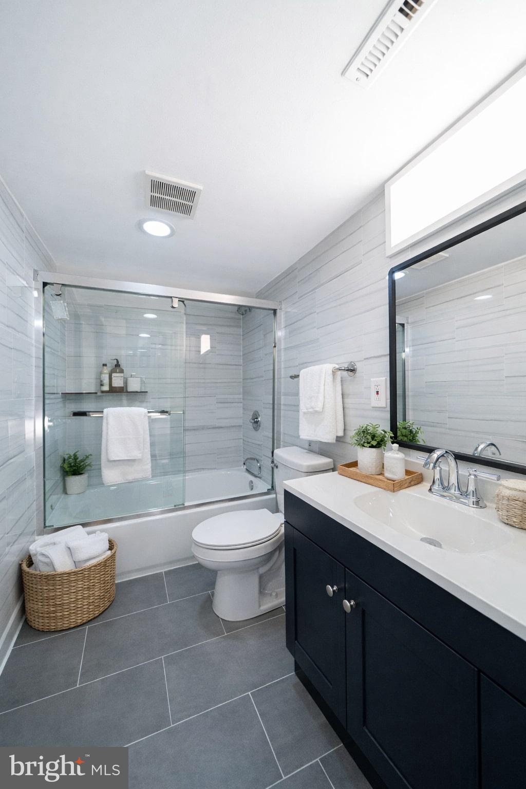 8659 Fayette Street Philadelphia, PA 19150 - Photo 12 of 47 a spacious bathroom with a double vanity sink toilet and a mirror
