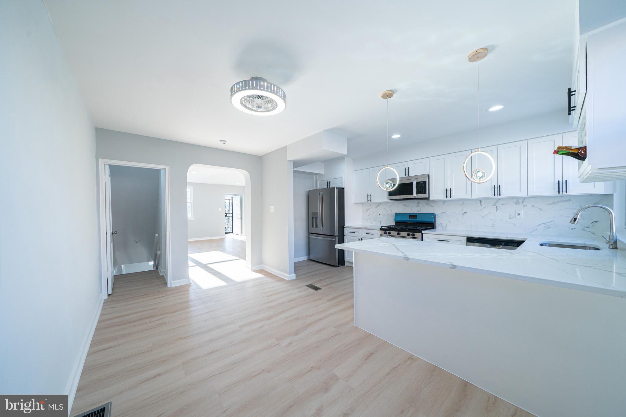 8659 Fayette Street Philadelphia, PA 19150 - Photo 18 of 47 a large white kitchen with wooden floors and view living room
