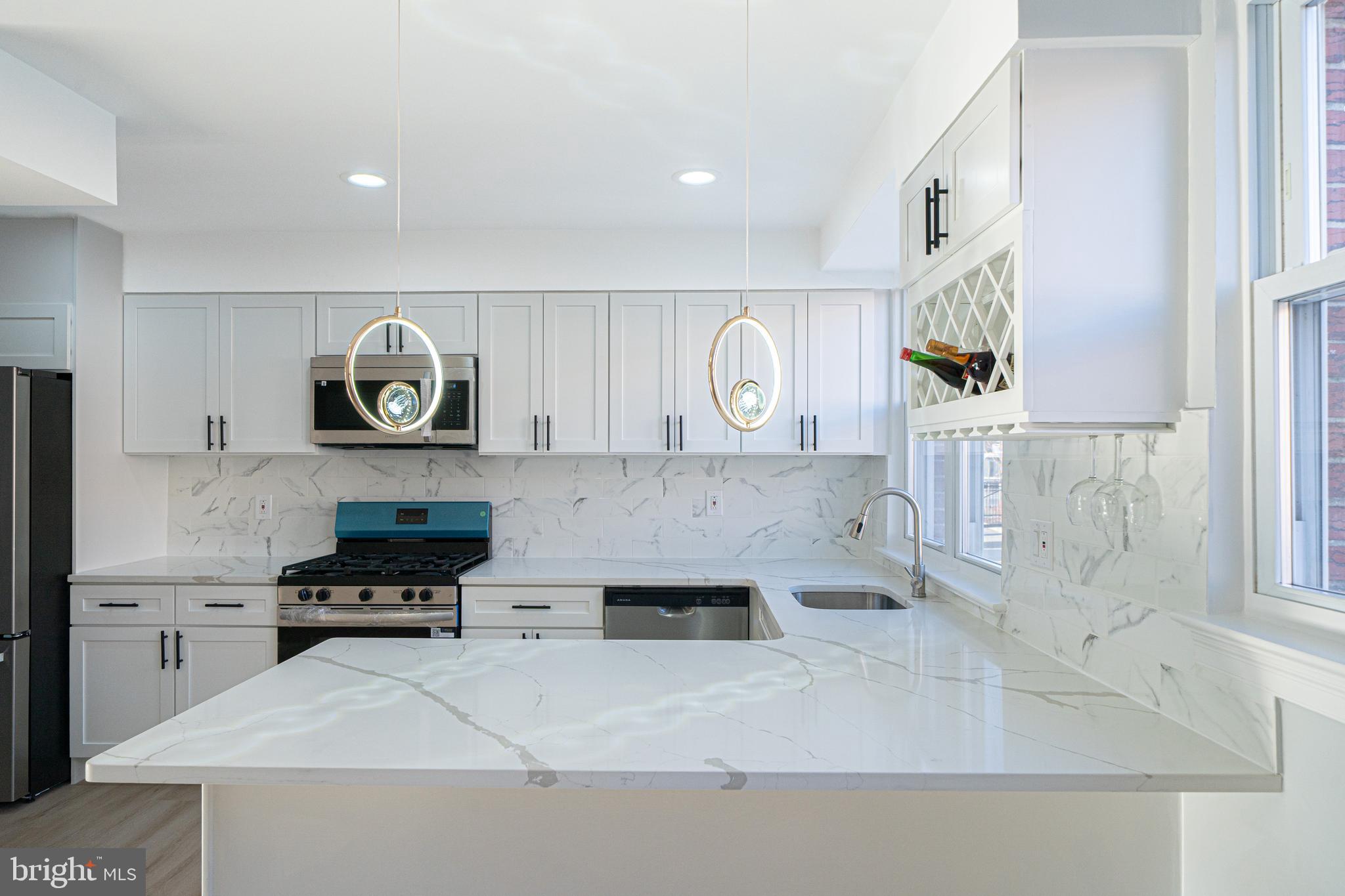 8659 Fayette Street Philadelphia, PA 19150 - Photo 20 of 47 a kitchen with stainless steel appliances granite countertop a stove and a refrigerator