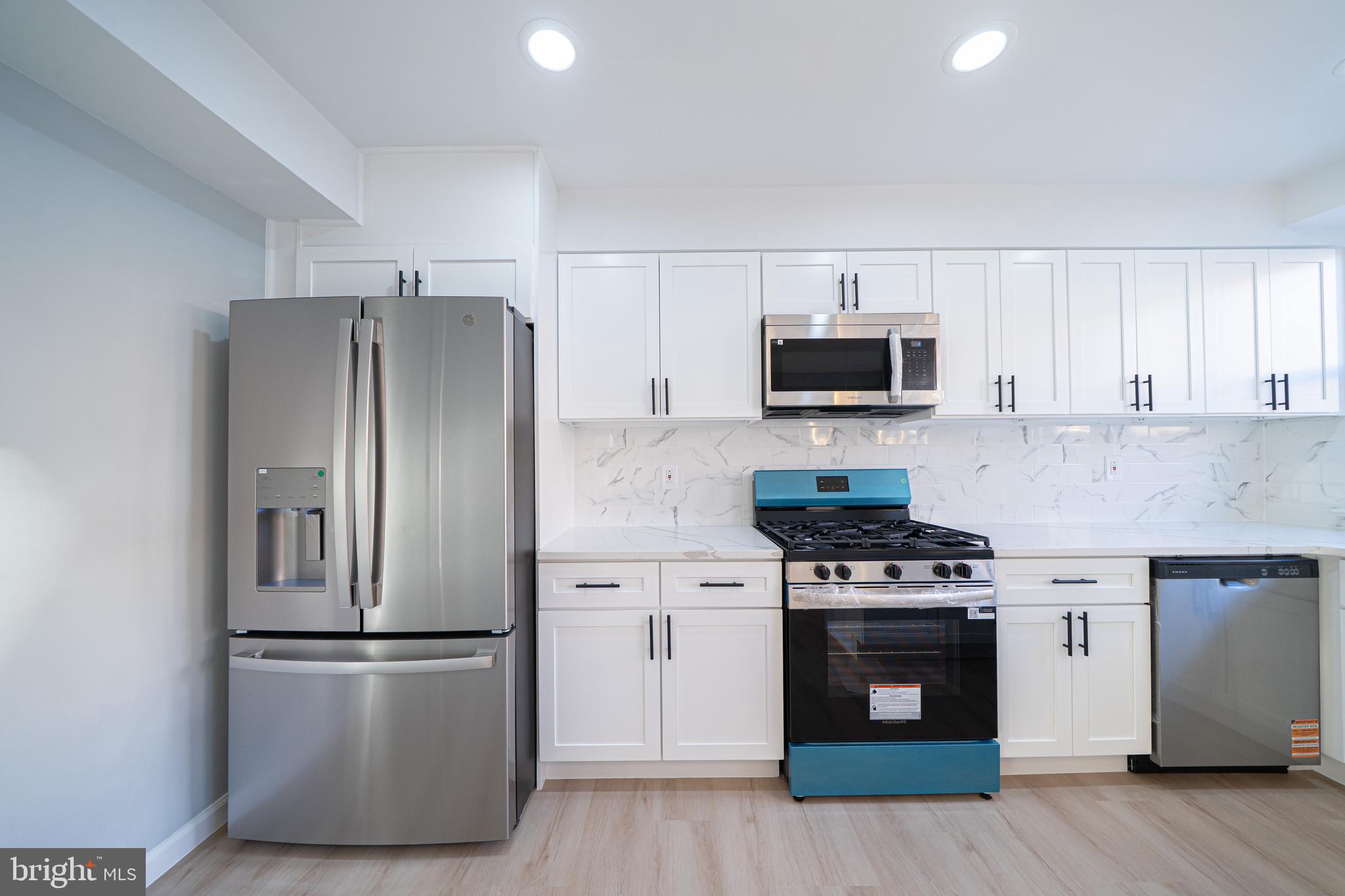 8659 Fayette Street Philadelphia, PA 19150 - Photo 21 of 47 a kitchen with stainless steel appliances a refrigerator stove and microwave