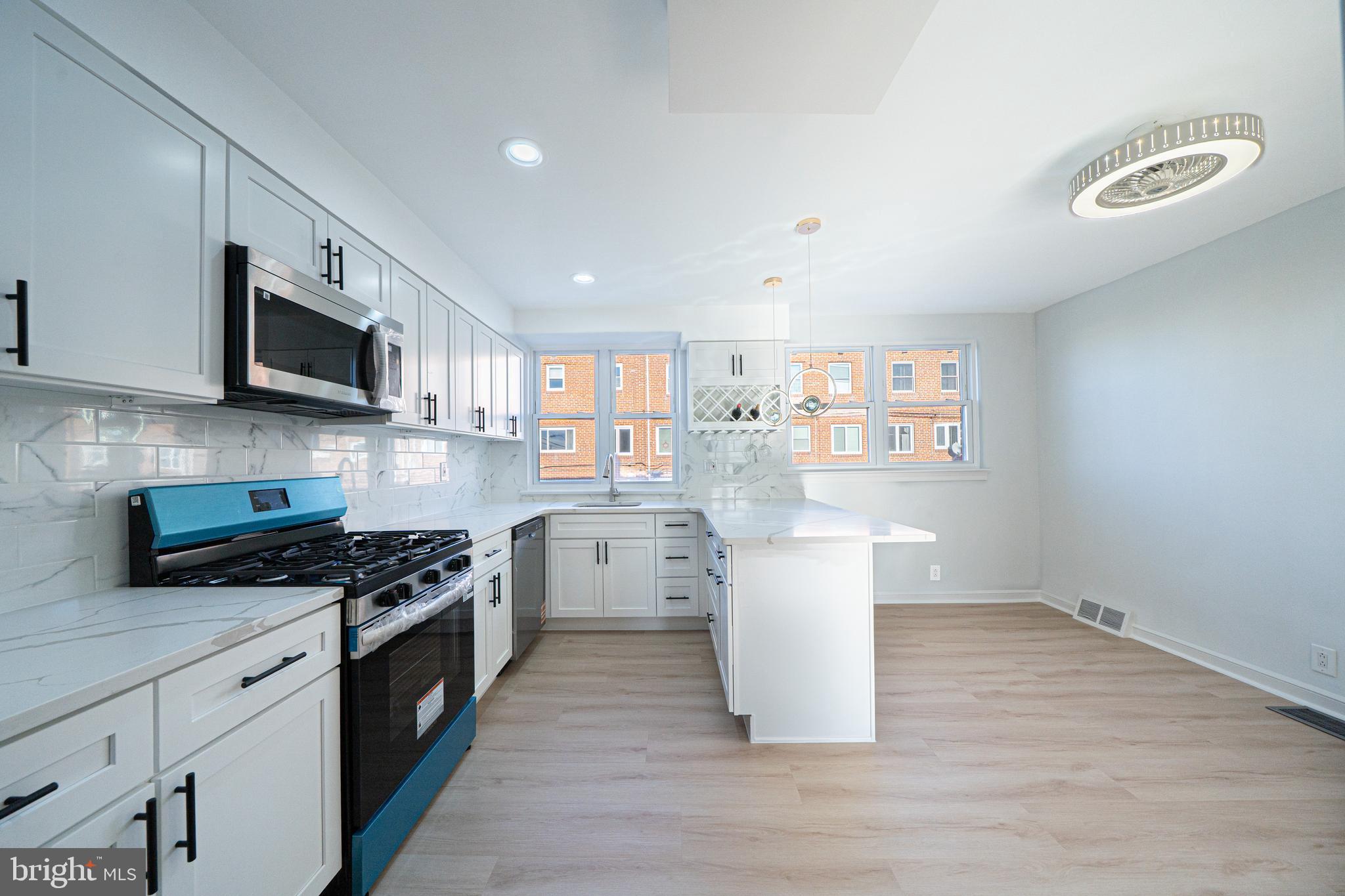 8659 Fayette Street Philadelphia, PA 19150 - Photo 23 of 47 a kitchen with a sink stove top oven and cabinets
