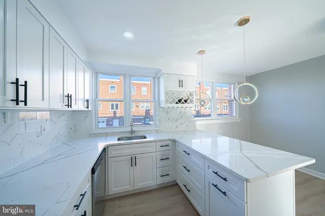 a kitchen with cabinets appliances and a window