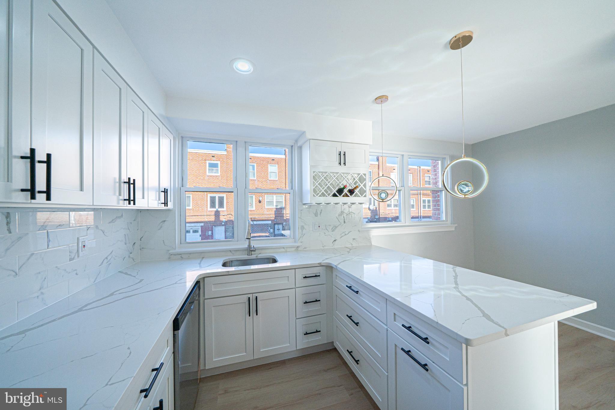 8659 Fayette Street Philadelphia, PA 19150 - Photo 24 of 47 a kitchen with cabinets appliances and a window