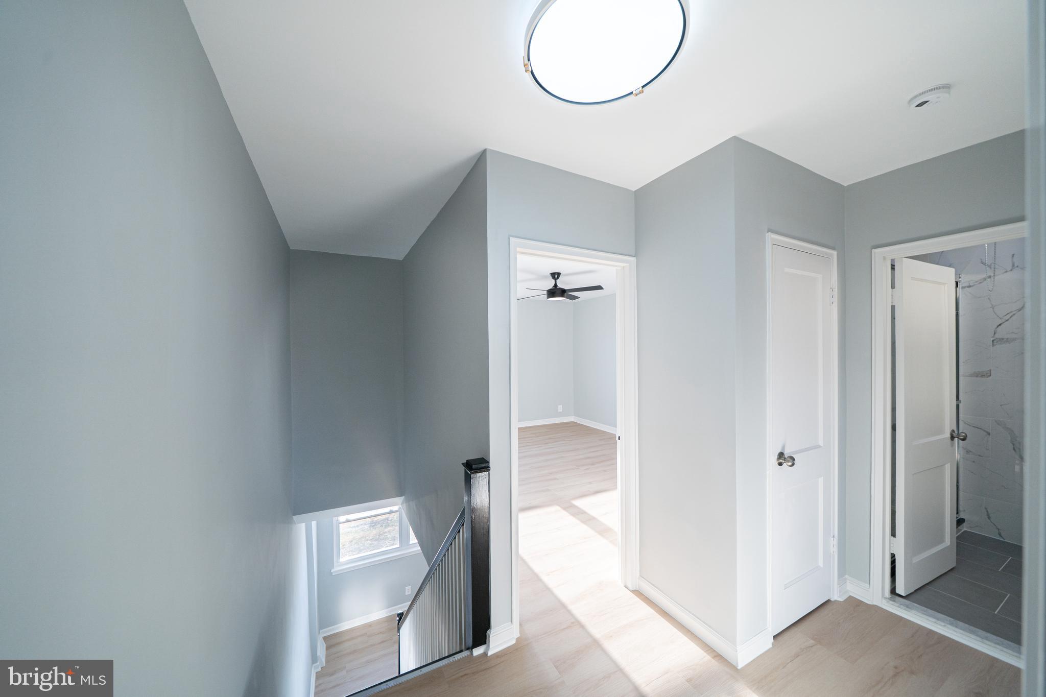 8659 Fayette Street Philadelphia, PA 19150 - Photo 25 of 47 a hallway with wooden floor and glass doors