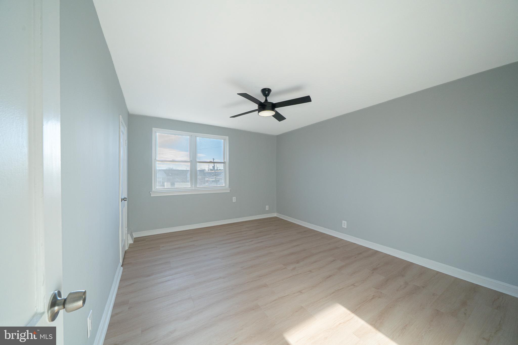 8659 Fayette Street Philadelphia, PA 19150 - Photo 26 of 47 an empty room with wooden floor and windows