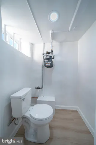 a white toilet sitting next to a bathroom sink and vanity
