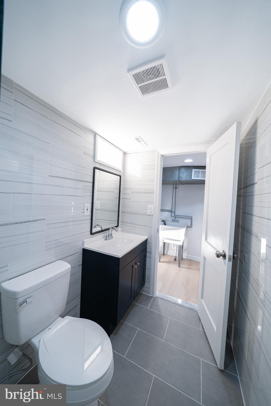 8659 Fayette Street Philadelphia, PA 19150 - Photo 40 of 47 a bathroom with a toilet sink and mirror