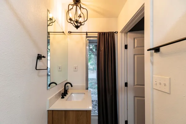 a bathroom with a shower and a sink