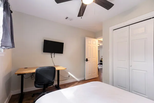 a bedroom with bed and a window