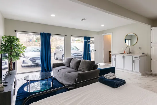 a kitchen that has a sink stainless steel appliances a counter space and a window
