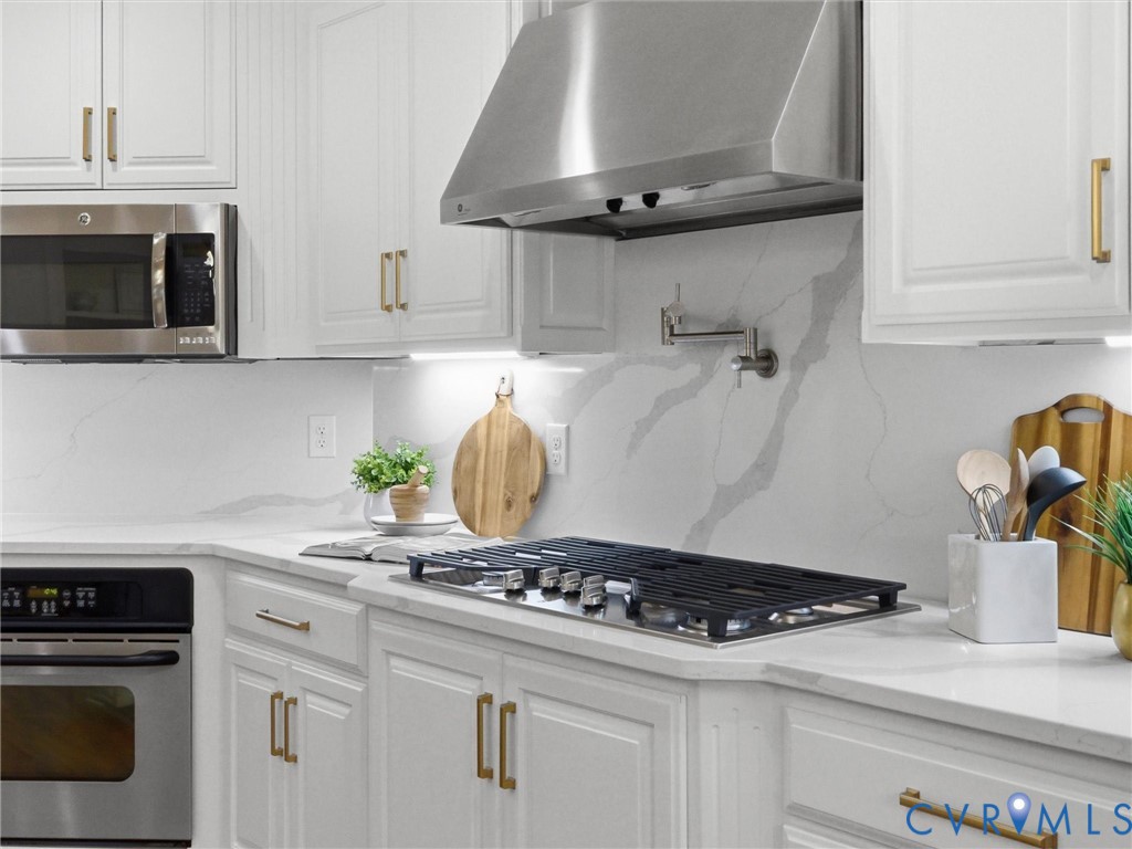 14335 Lander Road Midlothian, VA 23113 - Photo 18 of 70 a kitchen with a stove and white cabinets