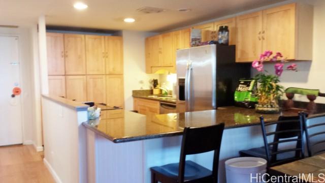 a kitchen with stainless steel appliances granite countertop sink refrigerator and microwave