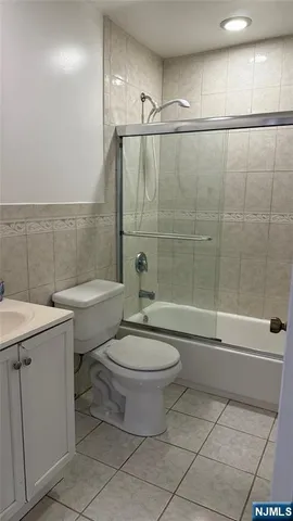 a bathroom with a toilet sink and shower
