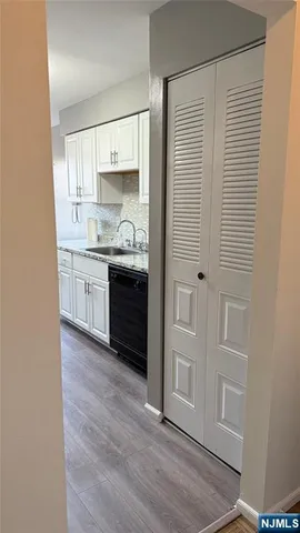 a view of kitchen with granite countertop cabinets and sink
