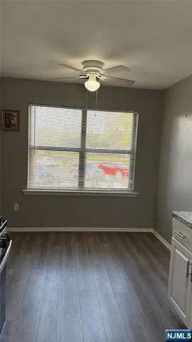 a view of room with wooden floor and windows