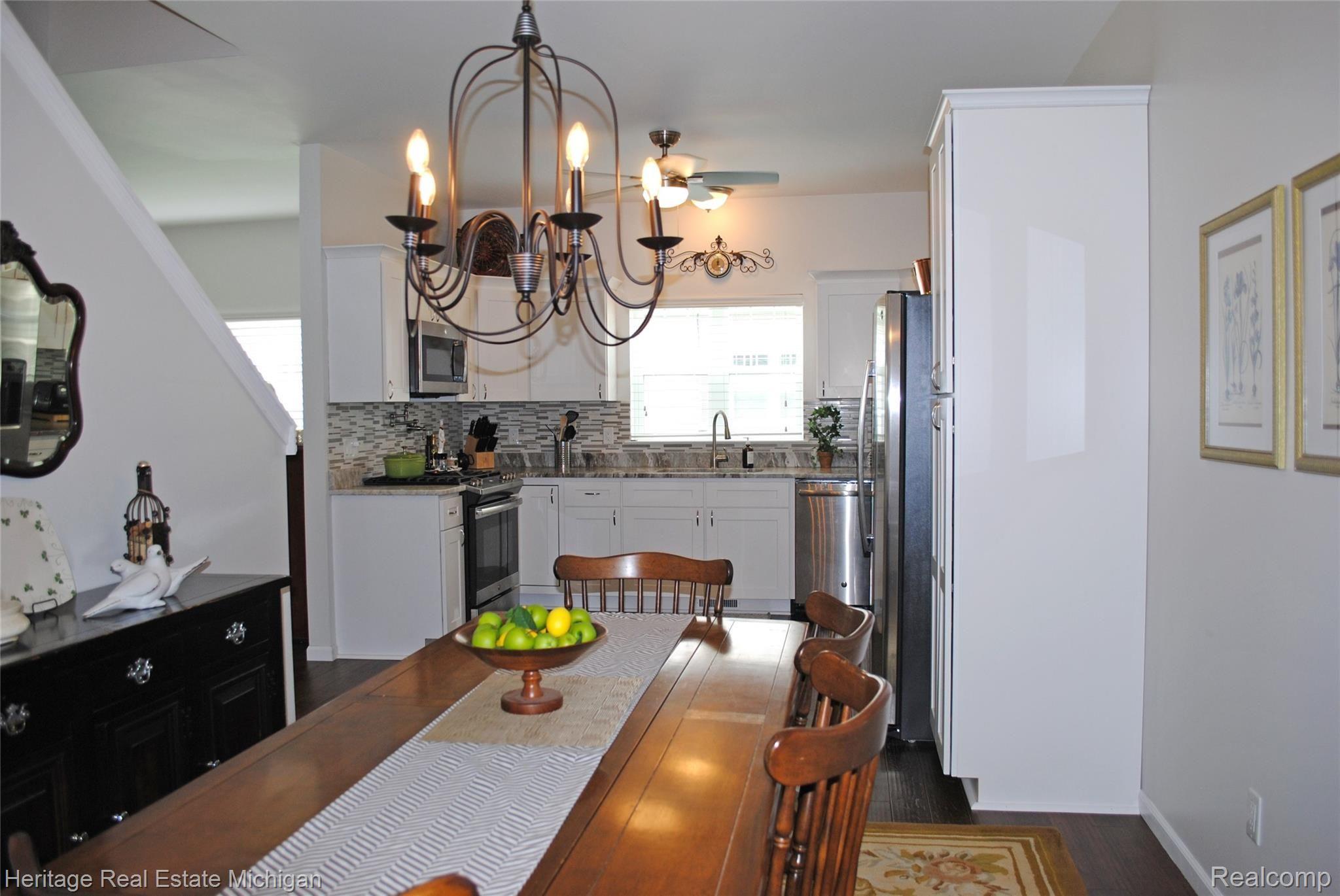 Another view of the dining area, kitchen and artistic lighting specially selected by the homeowners!