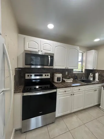 a kitchen with a stove and a microwave