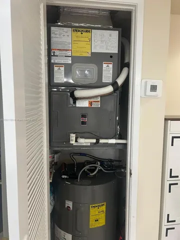 a utility room with a stove and a air conditioner