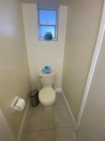 a white toilet sitting next to a small sink