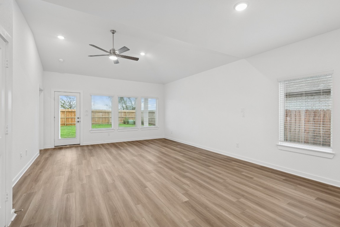 3422 Fresh Bluestream Lane Rosenberg, TX 77471 - Photo 13 of 48 a view of an empty room with a window and wooden floor