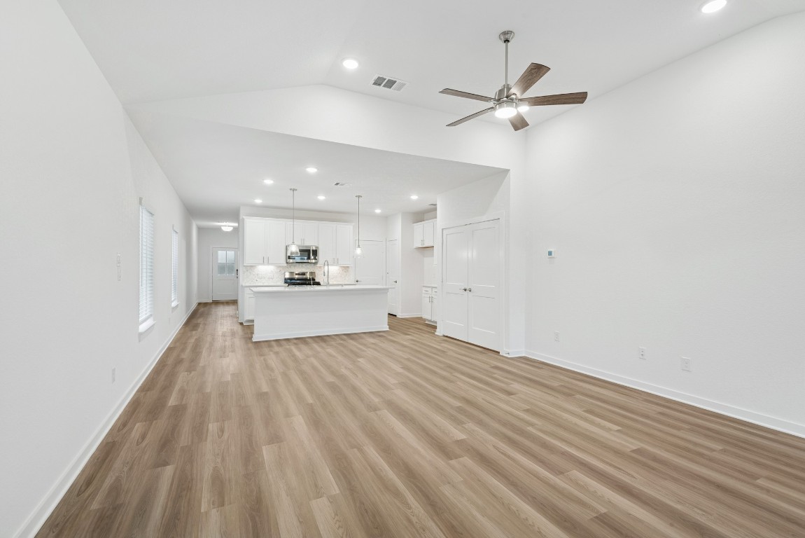 3422 Fresh Bluestream Lane Rosenberg, TX 77471 - Photo 27 of 48 a view of a livingroom with a ceiling fan and wooden floor