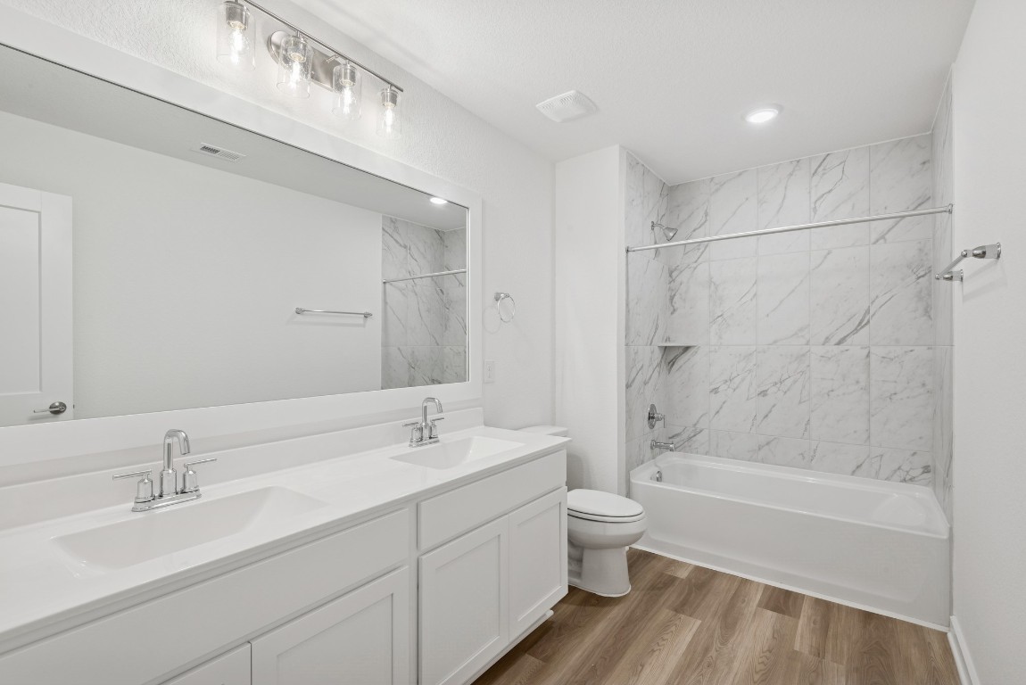 3422 Fresh Bluestream Lane Rosenberg, TX 77471 - Photo 40 of 48 a bathroom with a double vanity sink toilet mirror and bathtub