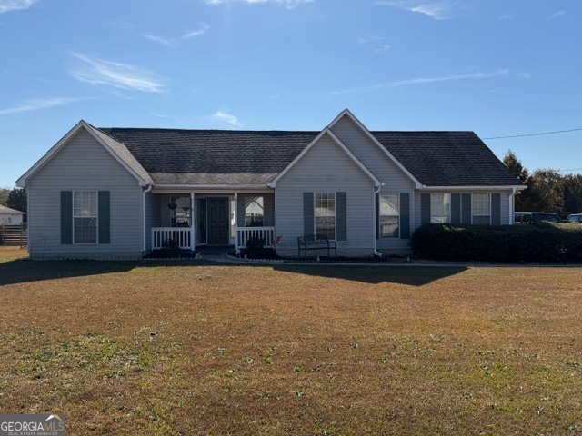 a front view of a house with yard and garage