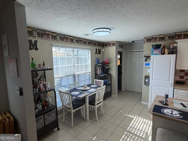 a dining room with furniture and a window