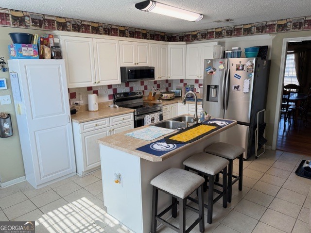 104 Tyler Court Macon, GA 31216 - Photo 18 of 33 a kitchen with stainless steel appliances a stove refrigerator sink and microwave