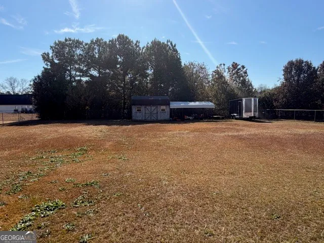 a swimming pool with trees in front of it
