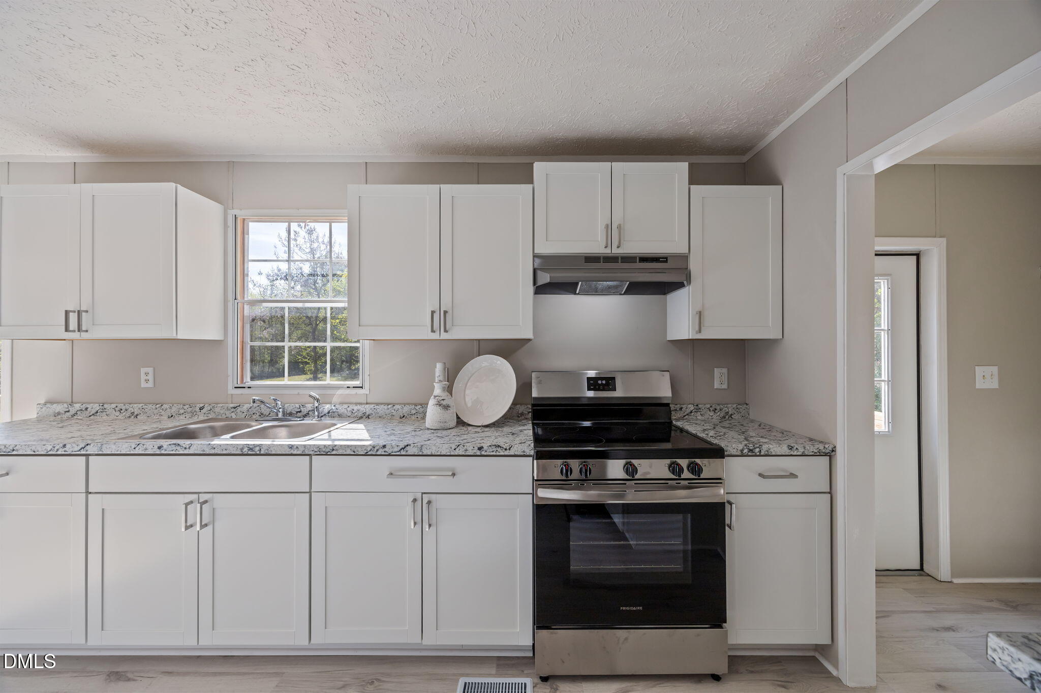 721 General Green Road Kittrell, NC 27544 - Photo 13 of 36 a kitchen with granite countertop a stove sink and cabinets