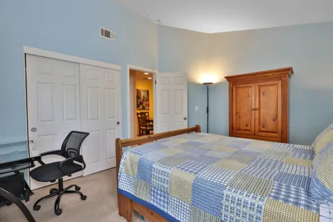 a bedroom with a bed and a chair