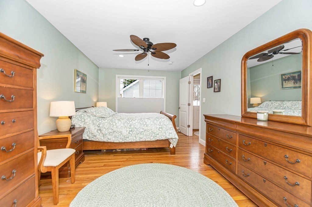 2a Ferry Road, Unit B Salisbury, MA 01952 - Photo 12 of 22 a bedroom with a bed a lamp on dresser and a chandelier