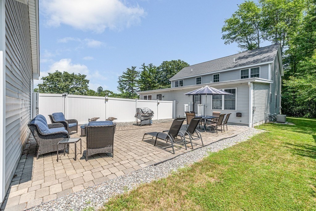 2a Ferry Road, Unit B Salisbury, MA 01952 - Photo 20 of 22 a view of a patio with table and chairs potted plants and a palm tree