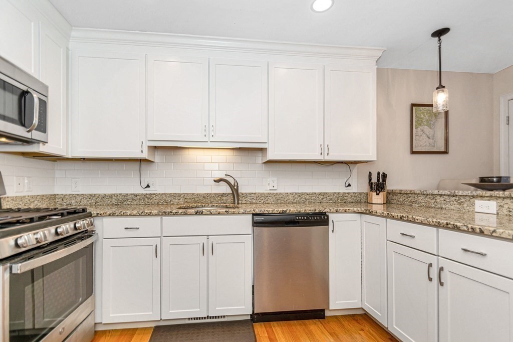 2a Ferry Road, Unit B Salisbury, MA 01952 - Photo 8 of 22 a kitchen with granite countertop white cabinets and stainless steel appliances