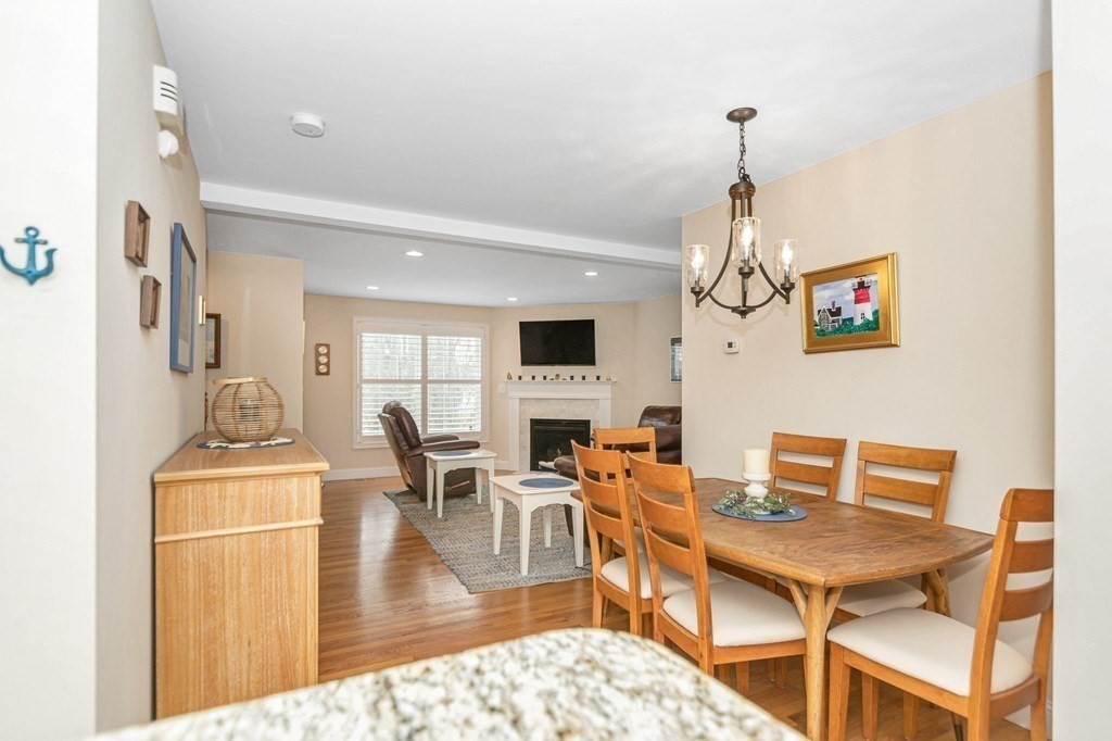 2a Ferry Road, Unit B Salisbury, MA 01952 - Photo 9 of 22 a dining room with wooden floor a chandelier a wooden table and chairs