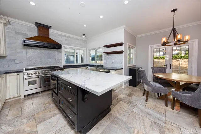 a kitchen with a stove window and chairs
