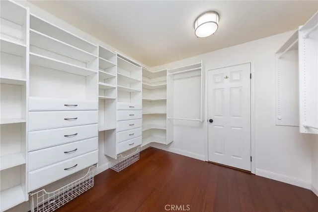 a view of walk in closet with empty racks