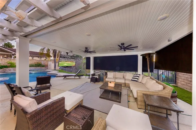 a outdoor space with furniture a large window and a fireplace