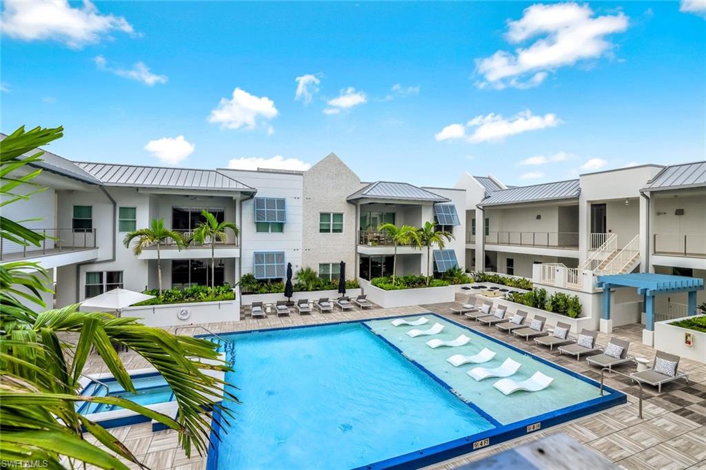 a view of a patio with swimming pool table and chairs