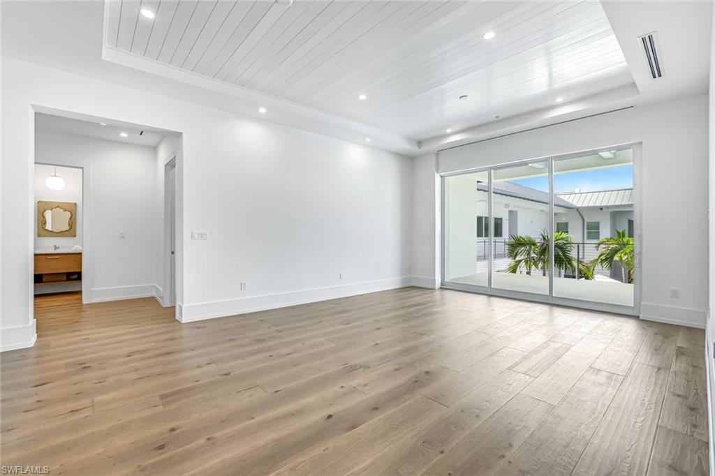 201 8th Street South, Unit 308 Naples, FL 34102 - Photo 11 of 28 a view of a big room with wooden floor and a table