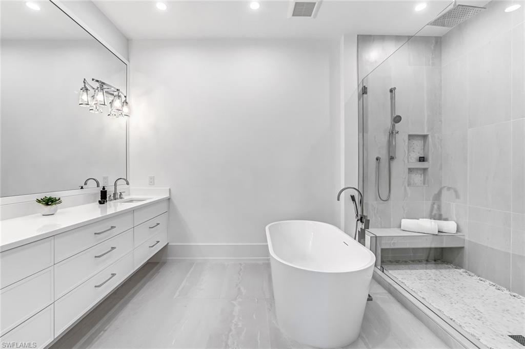 201 8th Street South, Unit 308 Naples, FL 34102 - Photo 15 of 28 a bathroom with a double vanity sink mirror and toilet