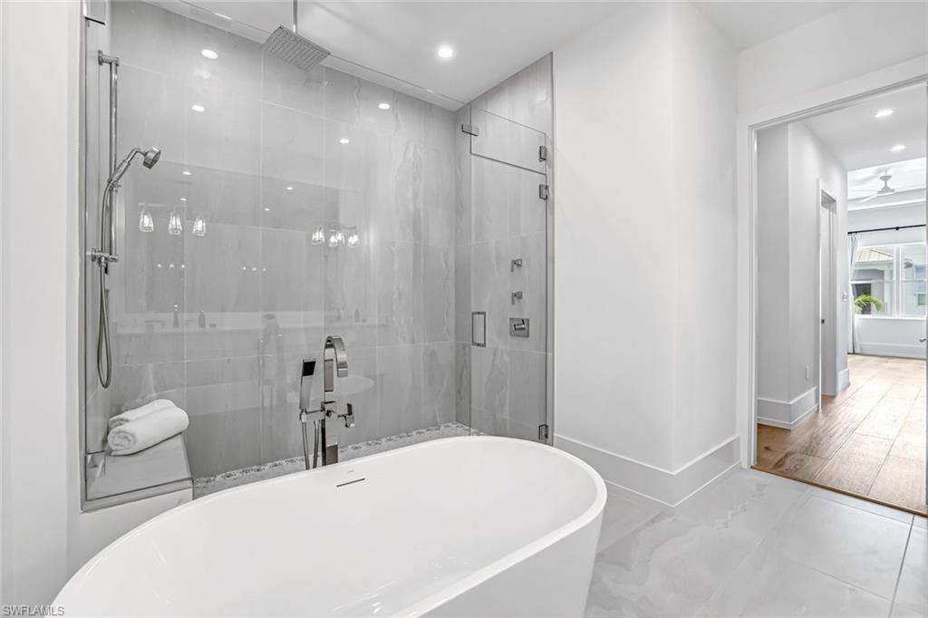 201 8th Street South, Unit 308 Naples, FL 34102 - Photo 17 of 28 a bathroom with a bathtub shower sink and toilet